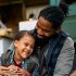 Happy black girl and her father enjoy during family camping day in nature.